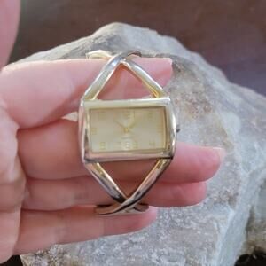 Gold Tone Cuff Bangle Watch with Rectangular Face and Crisscross Bracelet Design